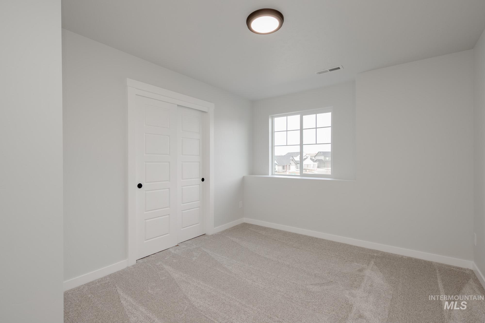2135 South Border Way Meridian, ID 83642 - Photo 22 of 24 Unfurnished bedroom featuring a closet and light carpet
