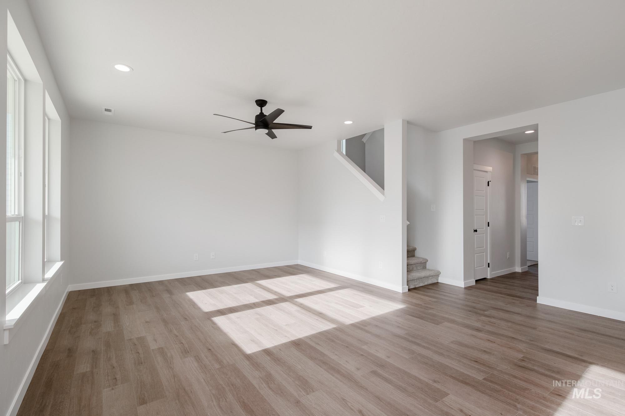 2135 South Border Way Meridian, ID 83642 - Photo 9 of 24 Unfurnished room featuring light wood-style flooring, a ceiling fan, and recessed lighting