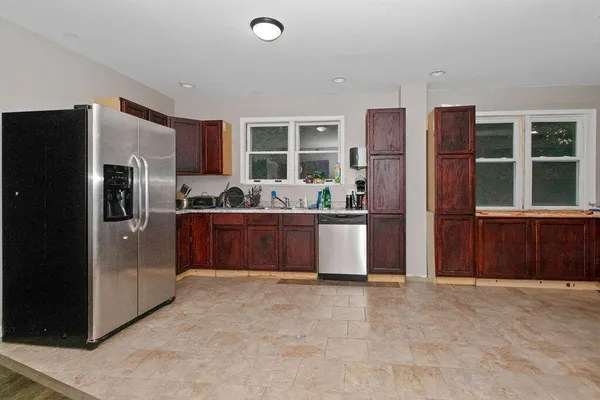 a kitchen with stainless steel appliances granite countertop a refrigerator and a sink