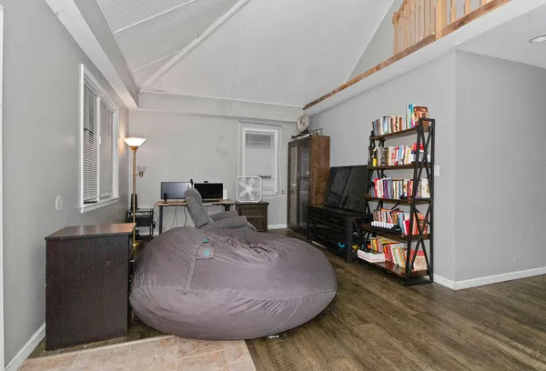 a living room with furniture and a wooden floor