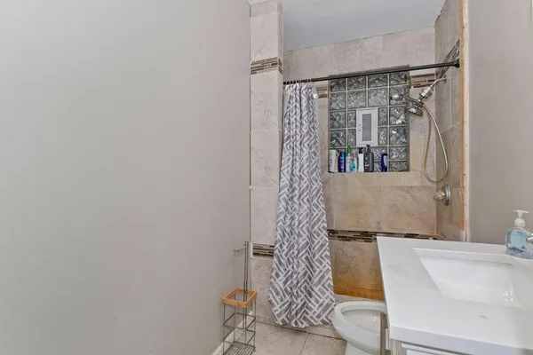 a bathroom with a sink toilet and shower