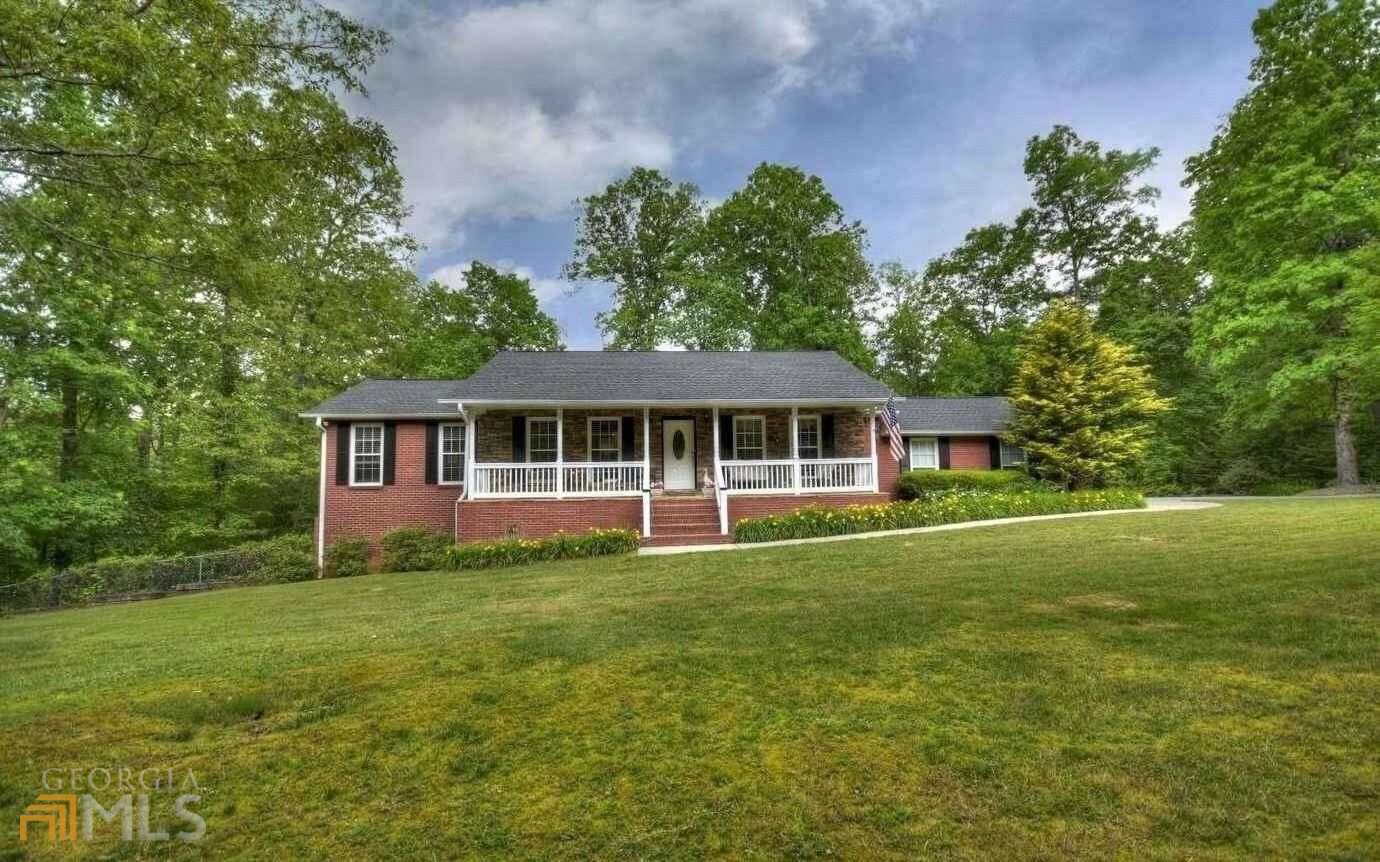 21 Pine Grove Drive Blue Ridge, GA 30513 - Photo 1 of 1 a front view of a house with a garden