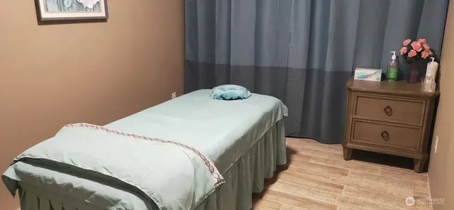 a spacious bedroom with a bed and a potted plant