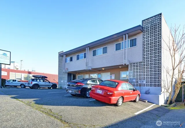 a front view of a house with cars parked