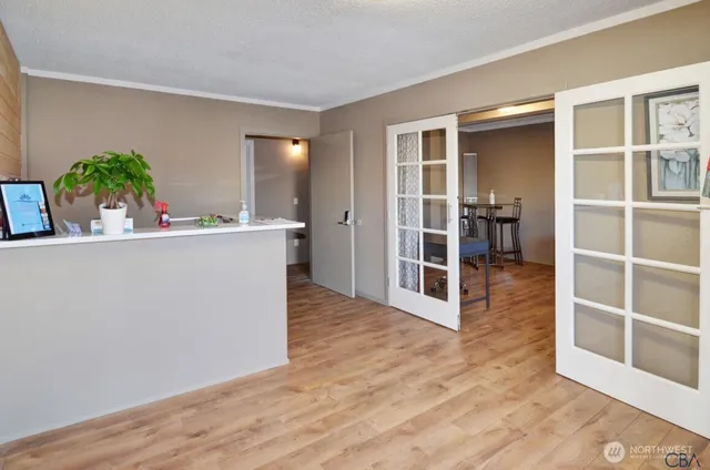 a view of a kitchen with furniture and wooden floor