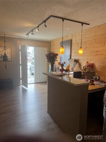 a kitchen with a sink and wooden floor