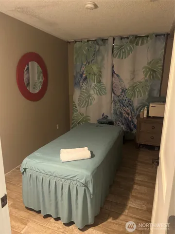 a bed sitting in a room next to a window