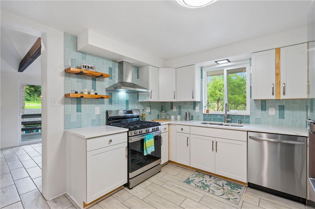 3326 New England Road West Mifflin, PA 15122 - Photo 11 of 46 a kitchen with a stove top oven sink and cabinets