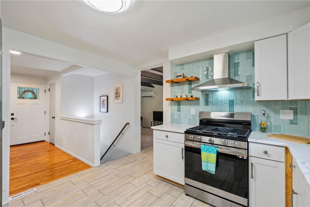 3326 New England Road West Mifflin, PA 15122 - Photo 13 of 46 a kitchen with stainless steel appliances a stove a sink and cabinets