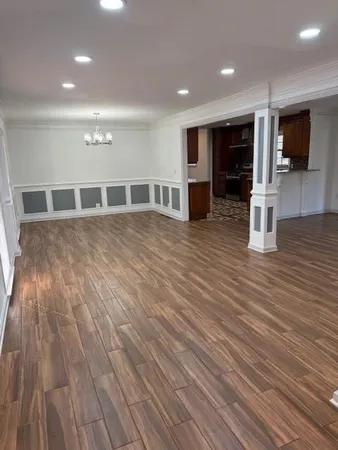 a view of a livingroom with an empty space and a flat screen tv