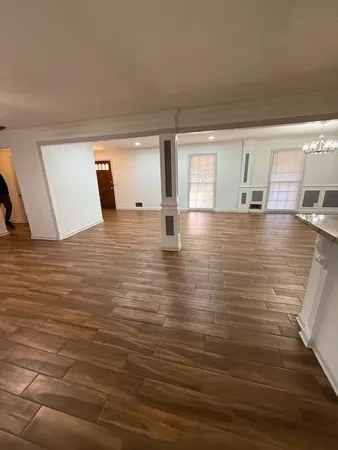 a view of a room with wooden floor