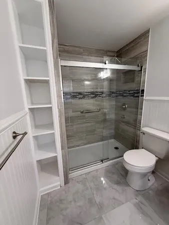 a bathroom with a toilet and a shower