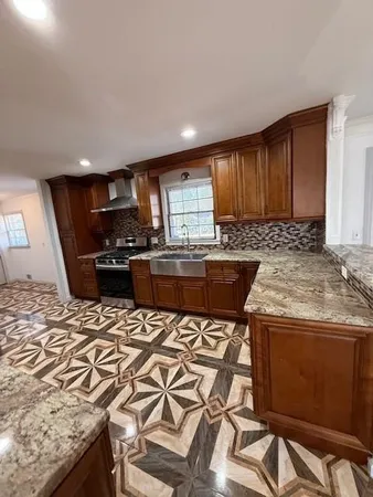 a kitchen with a stove a sink a microwave a dining table and chairs