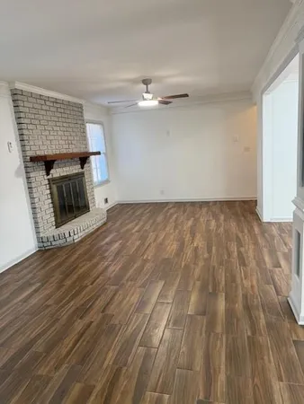 wooden floor in an empty room with a fireplace