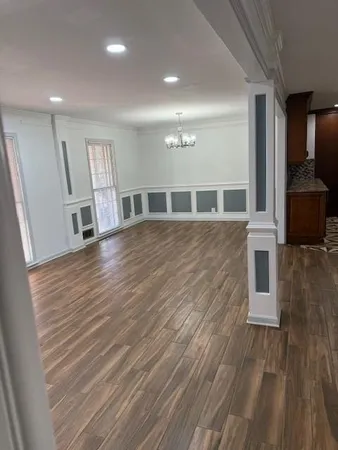 a view of a living room with wooden floor