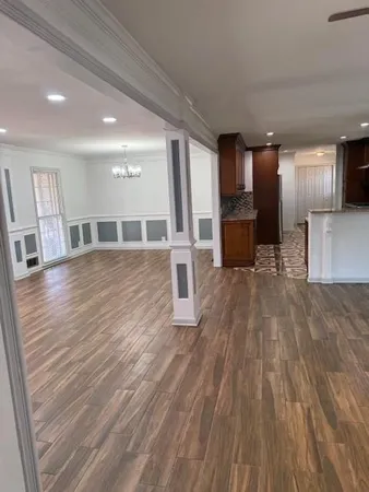 a big room with wooden floor and windows