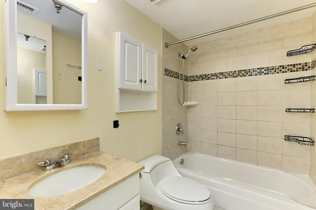 a bathroom with a sink toilet tub and shower