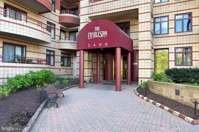 a front view of a building with a garden