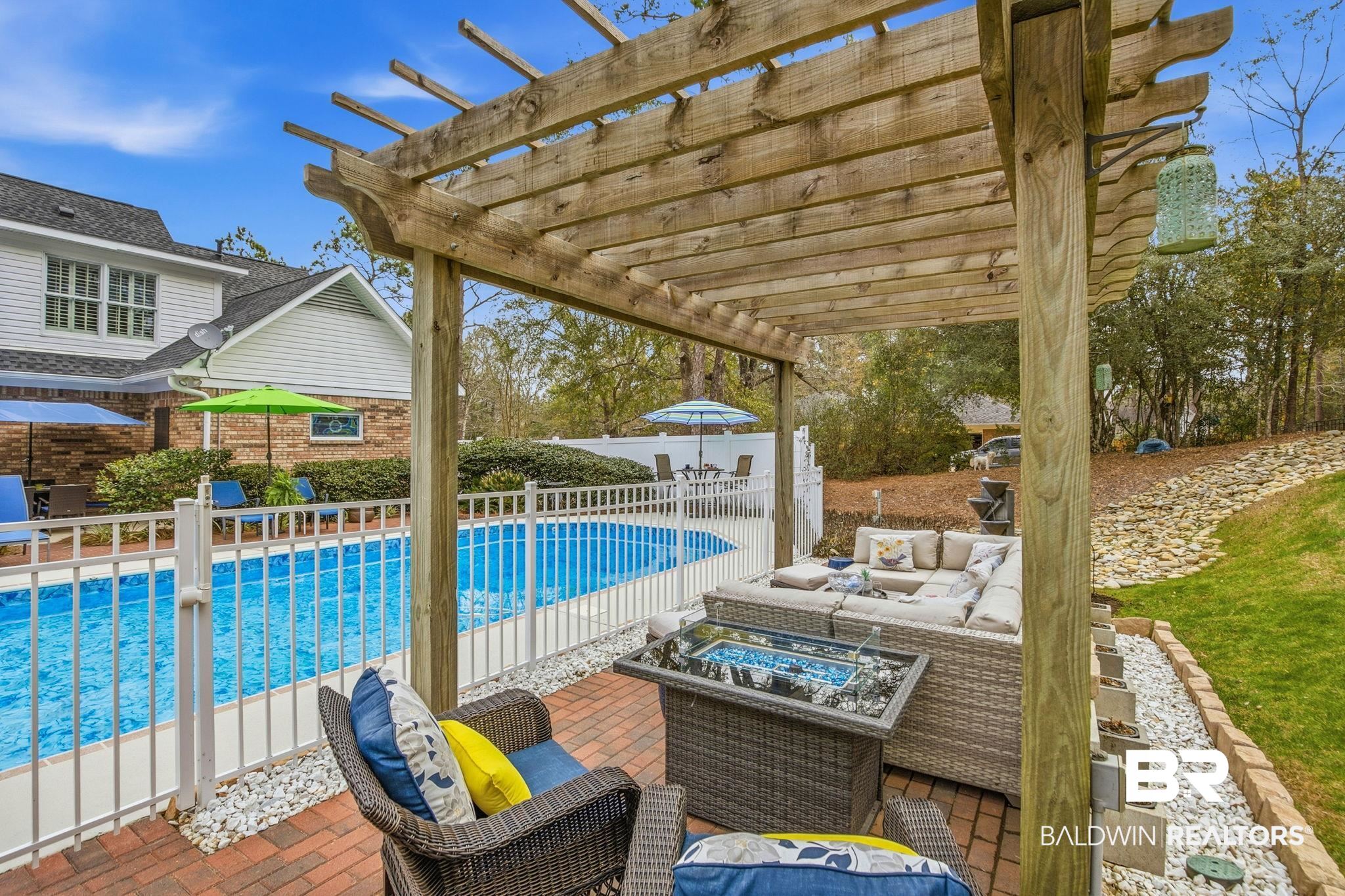 31515 Rhett Drive Spanish Fort, AL 36527 - Photo 78 of 100 Enjoy the evening sunsets with the fountain, outdoor seating area with fire pit. Pergola furniture & fire pit will convey with the home.