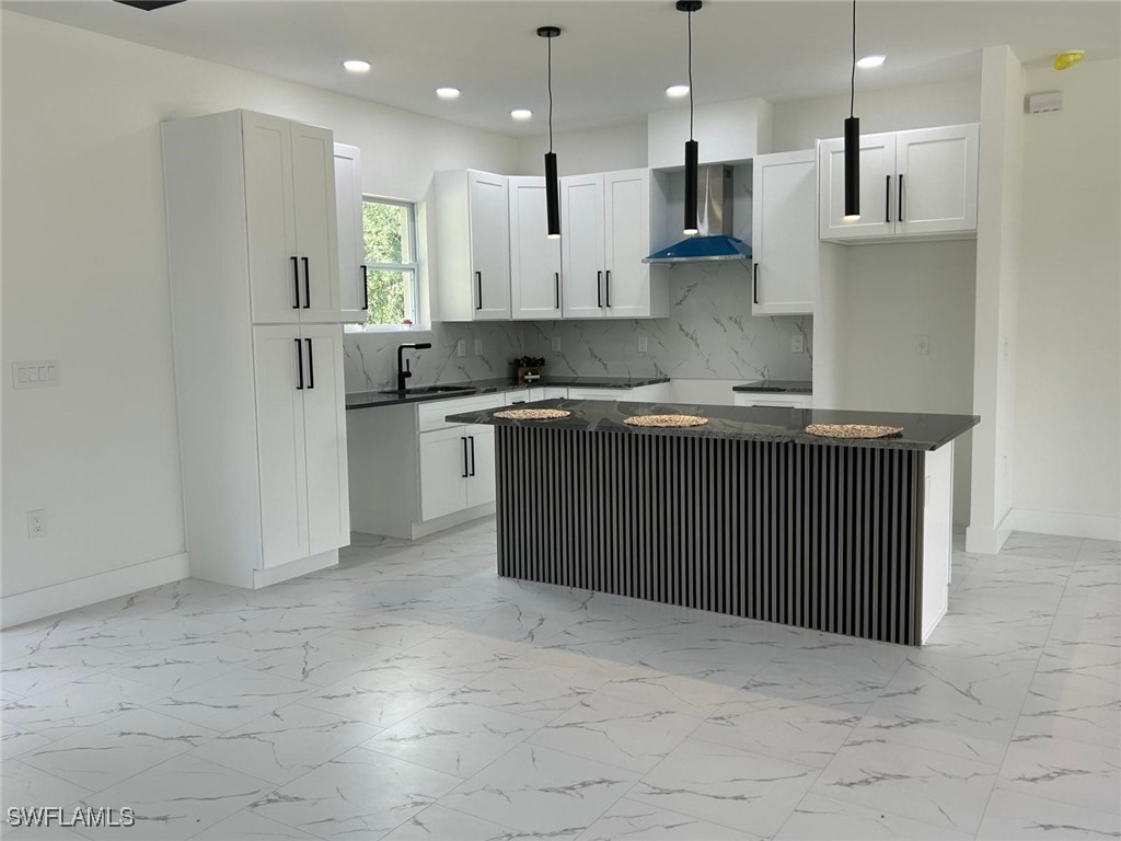4204 East 24th Street Alva, FL 33920 - Photo 11 of 34 a kitchen with stainless steel appliances granite countertop a sink a stove and a refrigerator