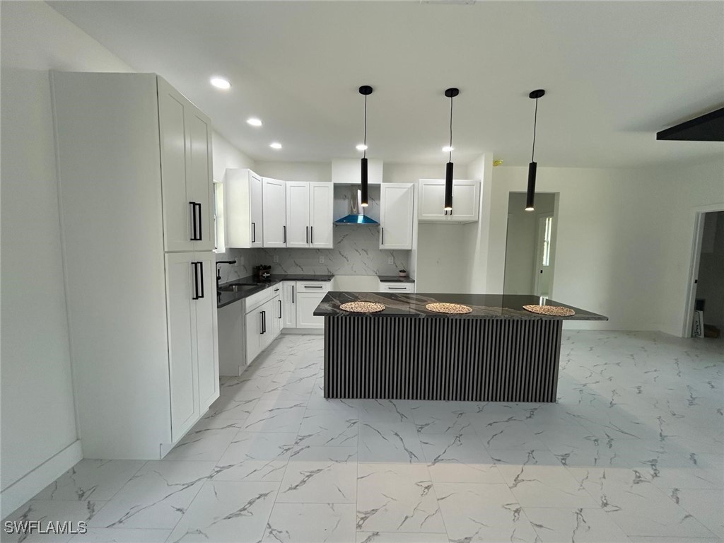 4204 East 24th Street Alva, FL 33920 - Photo 12 of 34 a kitchen with stainless steel appliances granite countertop a stove a sink and a refrigerator