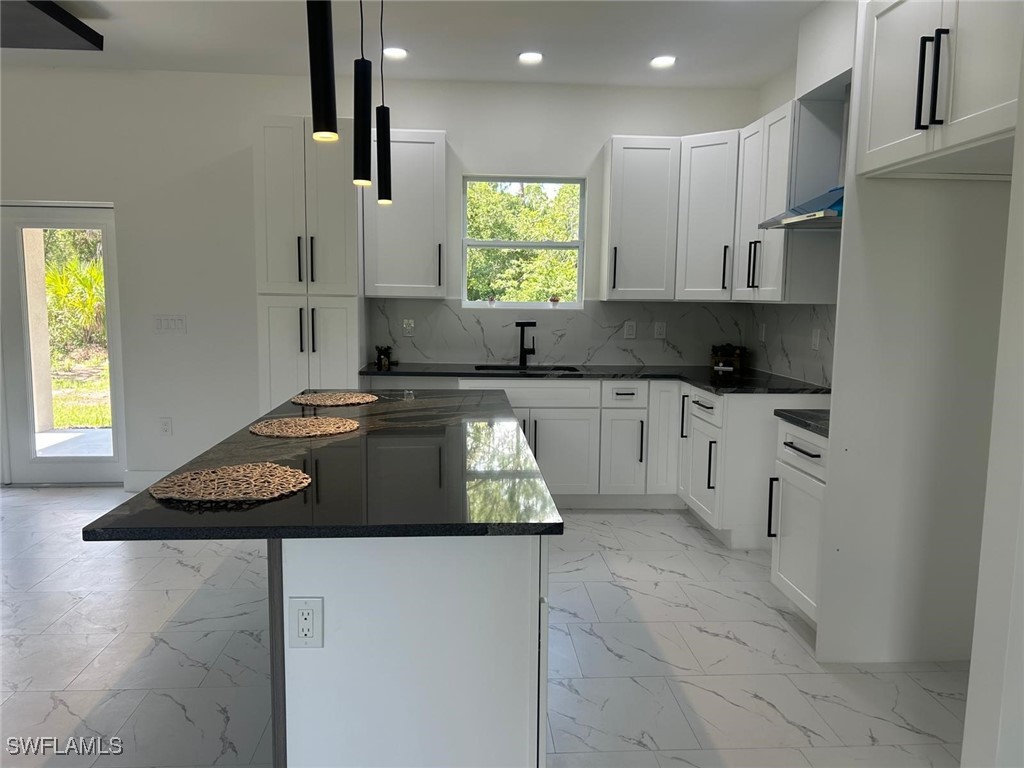 4204 East 24th Street Alva, FL 33920 - Photo 13 of 34 a kitchen with stainless steel appliances granite countertop a stove a sink and a microwave