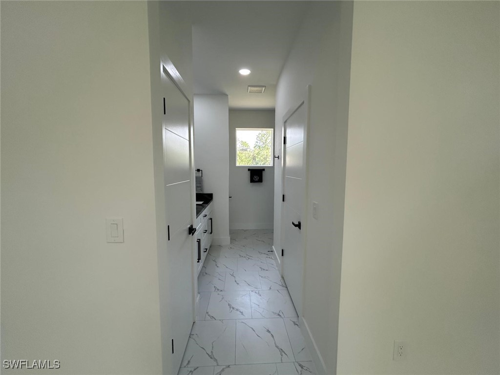 4204 East 24th Street Alva, FL 33920 - Photo 20 of 34 a view of a hallway with wooden shelves