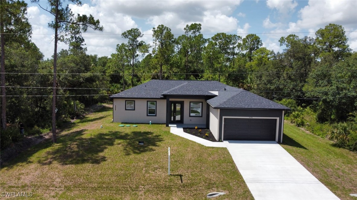 4204 East 24th Street Alva, FL 33920 - Photo 2 of 34 a front view of a house with a garden