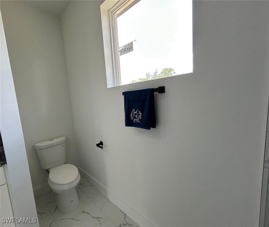 4204 East 24th Street Alva, FL 33920 - Photo 25 of 34 a white toilet sitting next to a bathroom sink