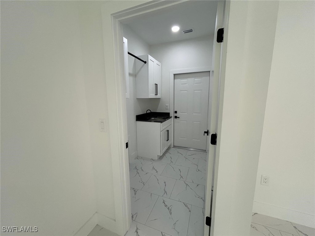 4204 East 24th Street Alva, FL 33920 - Photo 32 of 34 a bathroom with a sink and mirror