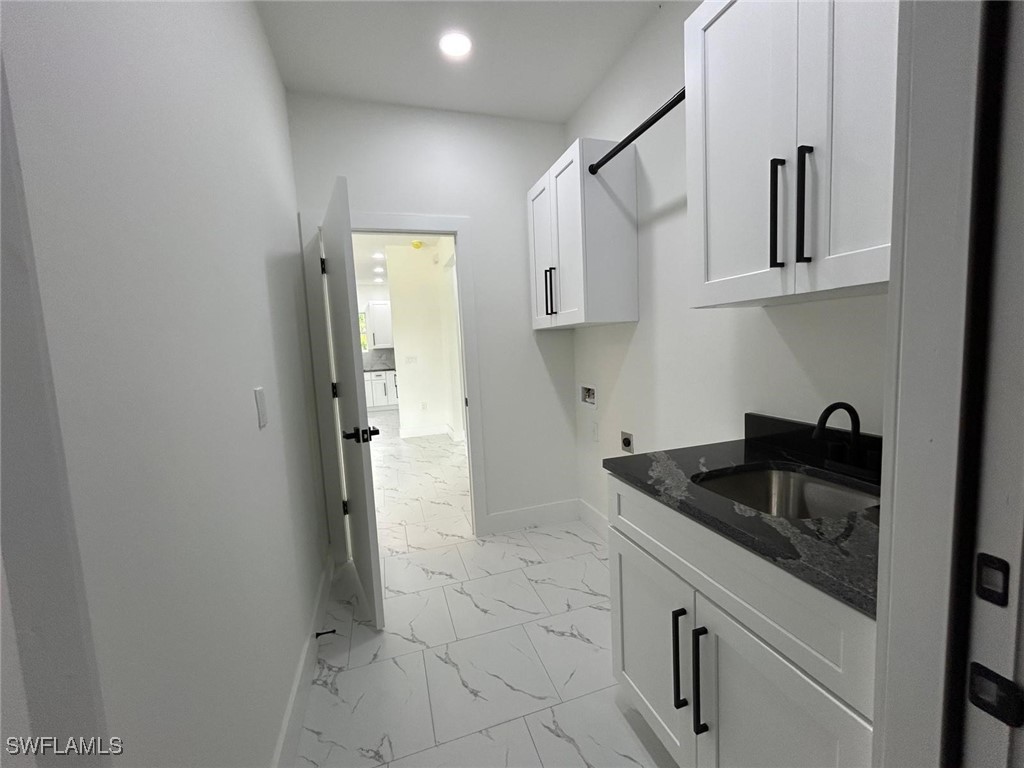 4204 East 24th Street Alva, FL 33920 - Photo 33 of 34 a kitchen with granite countertop white cabinets and stainless steel appliances