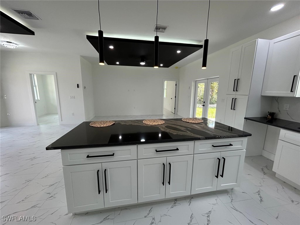 4204 East 24th Street Alva, FL 33920 - Photo 10 of 34 a kitchen with a sink a stove and cabinets