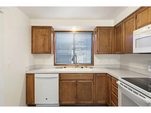 a kitchen with a sink cabinets and window
