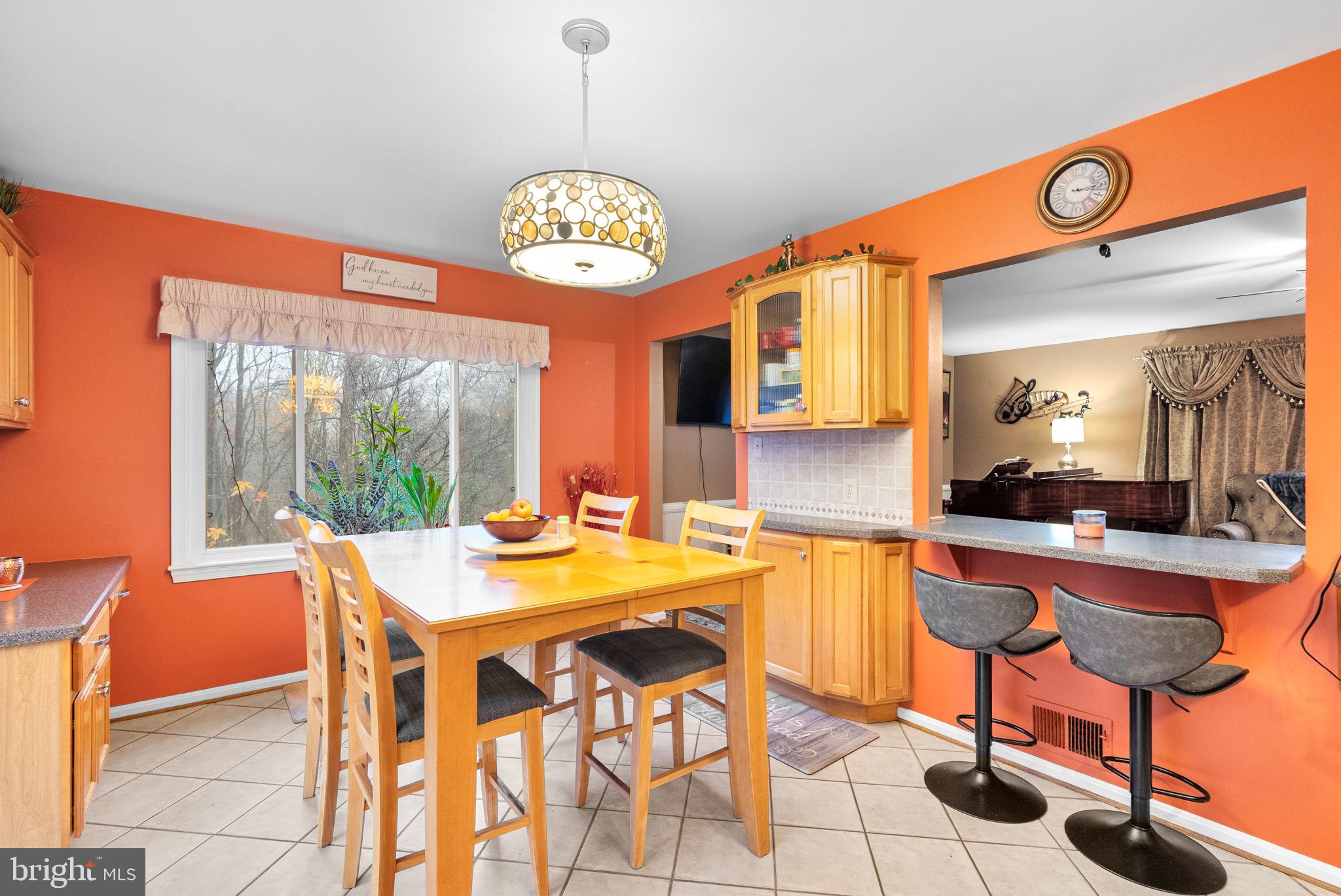 13100 Croom Road Upper Marlboro, MD 20772 - Photo 11 of 37 a view of a dining room with furniture a chandelier and wooden floor