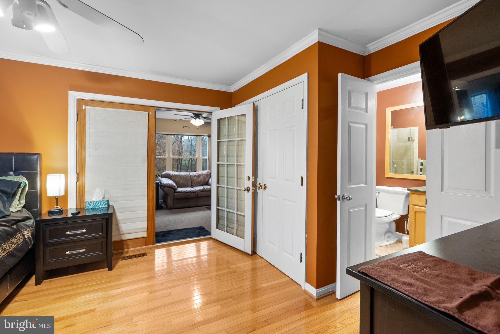 13100 Croom Road Upper Marlboro, MD 20772 - Photo 15 of 37 a bedroom with a bed and wooden floor