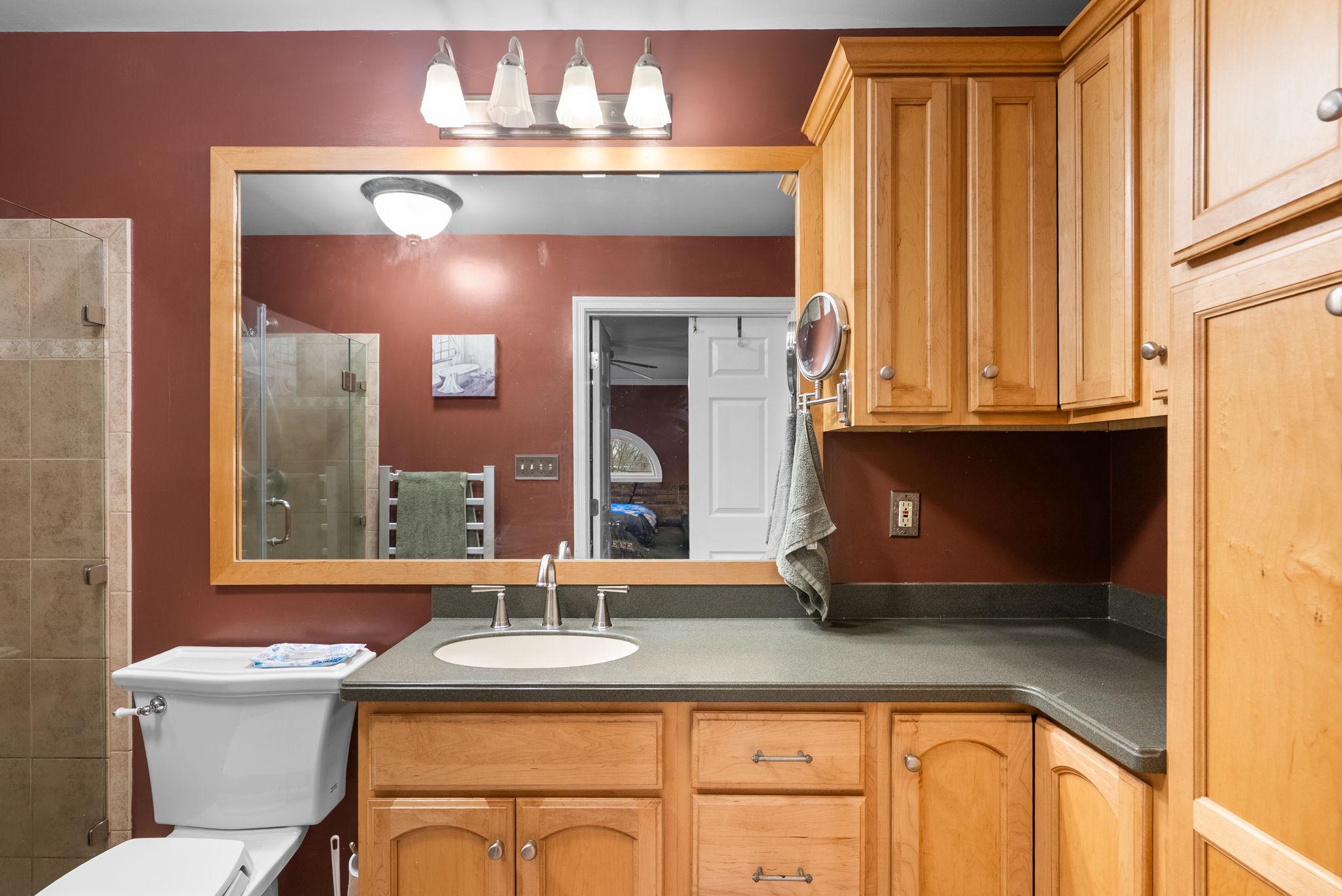 13100 Croom Road Upper Marlboro, MD 20772 - Photo 17 of 34 a bathroom with a granite countertop sink a toilet and mirror