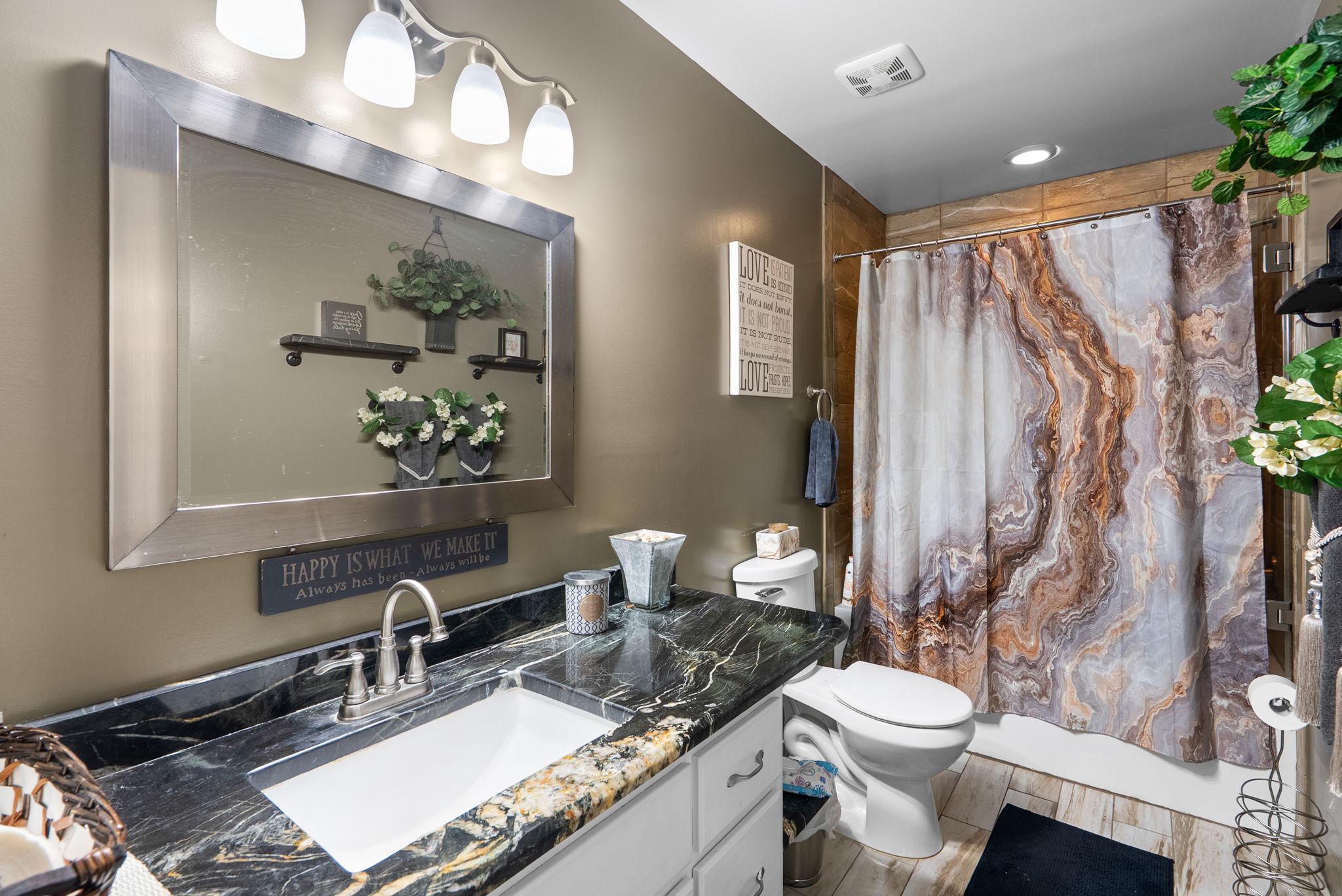 13100 Croom Road Upper Marlboro, MD 20772 - Photo 21 of 34 a bathroom with a granite countertop sink vanity mirror and toilet
