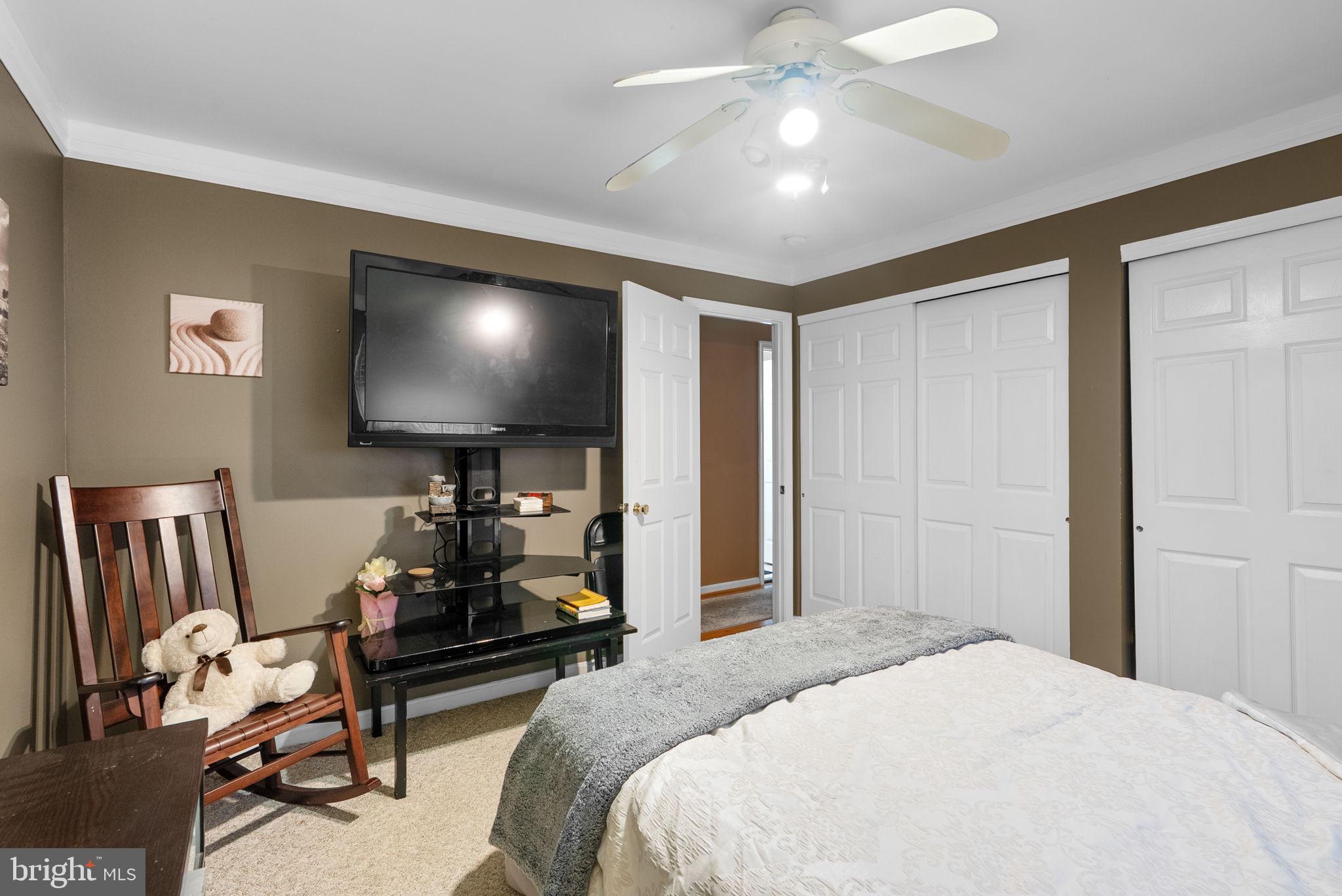 13100 Croom Road Upper Marlboro, MD 20772 - Photo 23 of 37 a bedroom with furniture and a flat screen tv