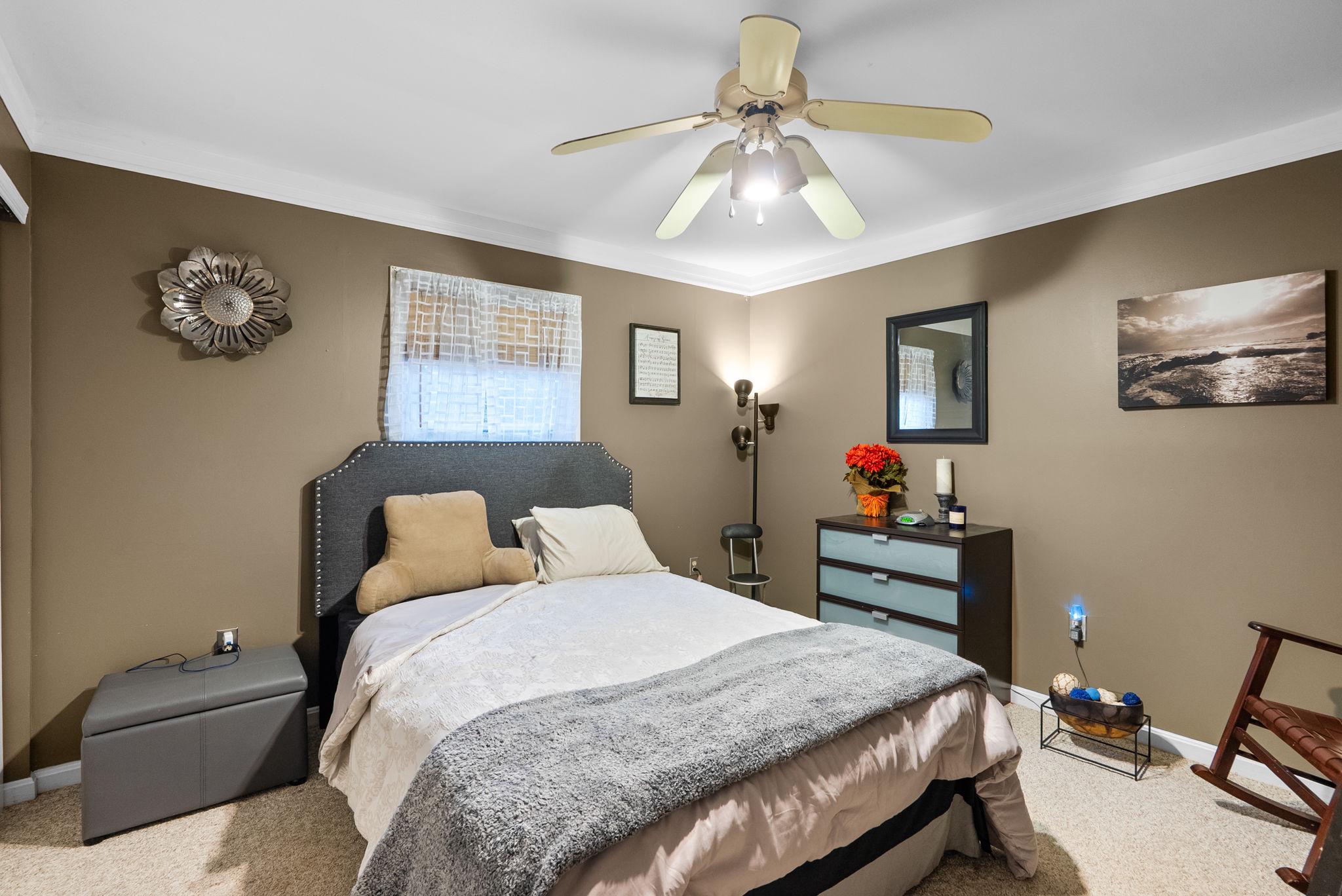 13100 Croom Road Upper Marlboro, MD 20772 - Photo 23 of 34 a bedroom with a bed and a chandelier