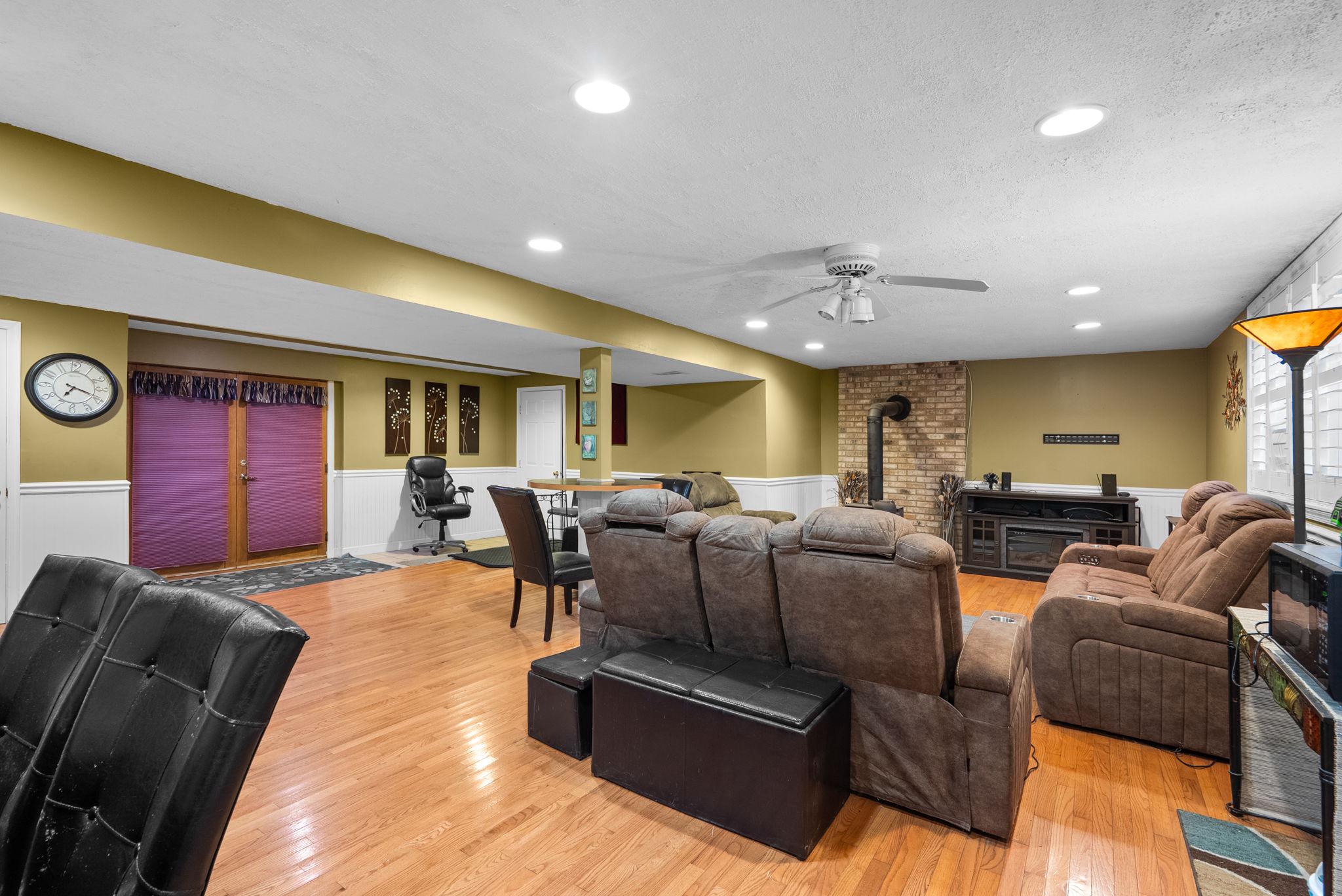 13100 Croom Road Upper Marlboro, MD 20772 - Photo 25 of 34 a living room with furniture a red lamp and a projector
