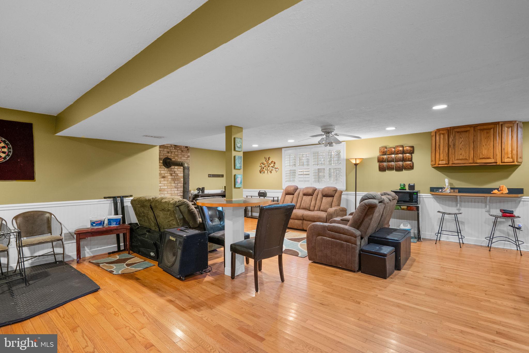 13100 Croom Road Upper Marlboro, MD 20772 - Photo 26 of 37 a living room with furniture and a flat screen tv