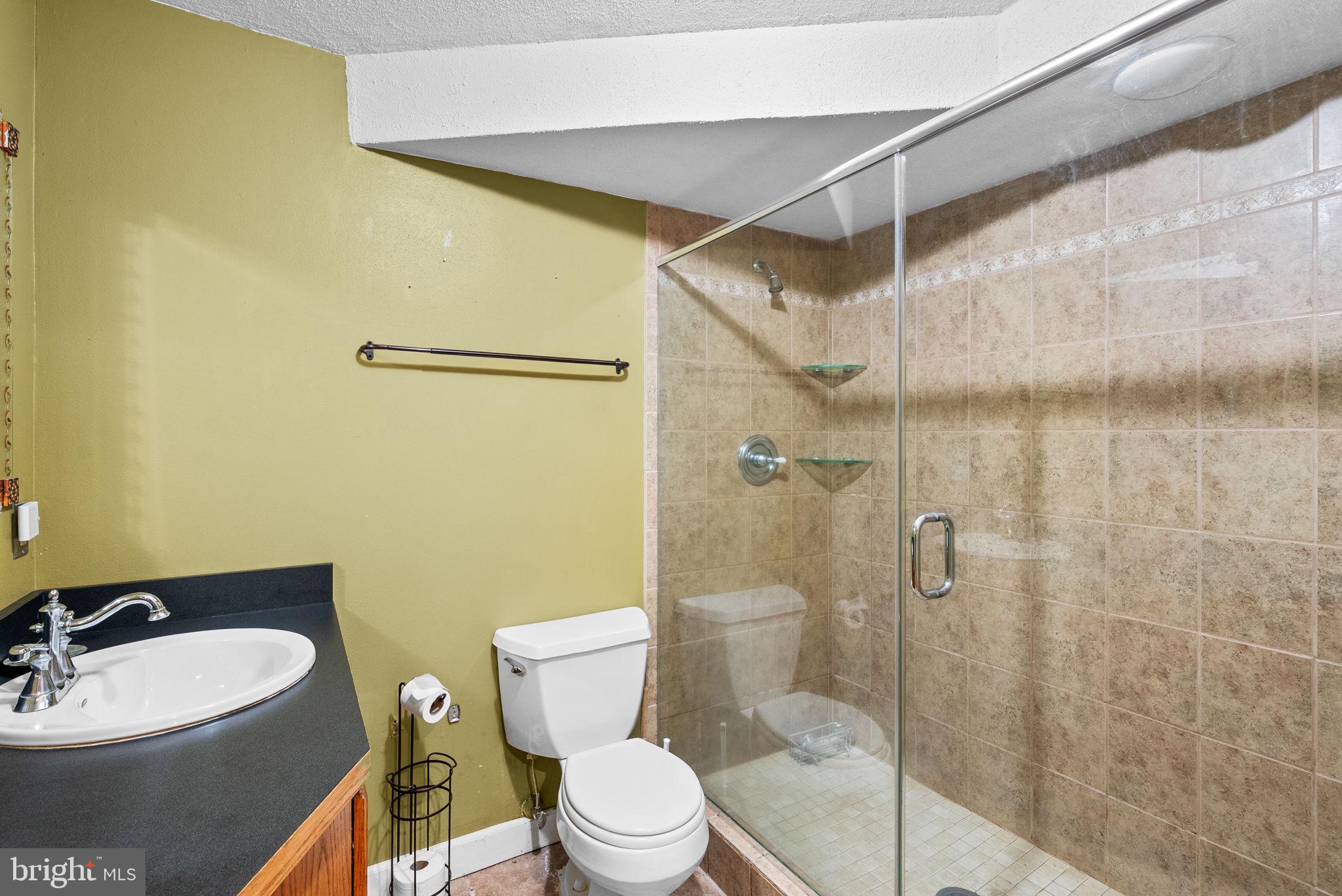 13100 Croom Road Upper Marlboro, MD 20772 - Photo 29 of 37 a bathroom with a toilet a sink and shower