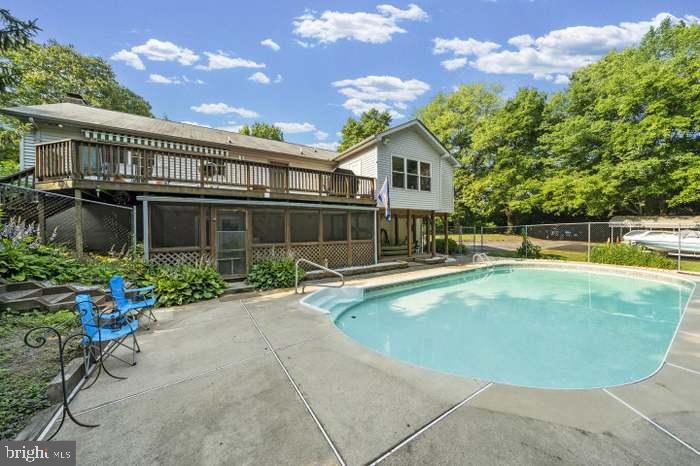 13100 Croom Road Upper Marlboro, MD 20772 - Photo 34 of 37 a view of a house with swimming pool and sitting area