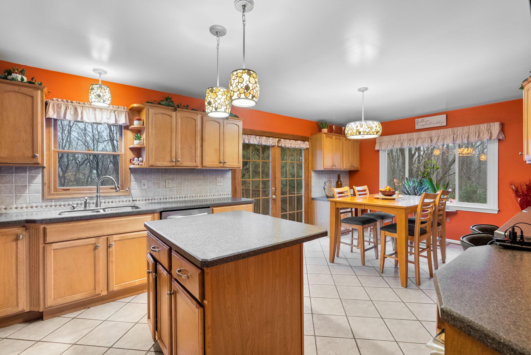 13100 Croom Road Upper Marlboro, MD 20772 - Photo 8 of 34 a open kitchen with a table chairs and white cabinets