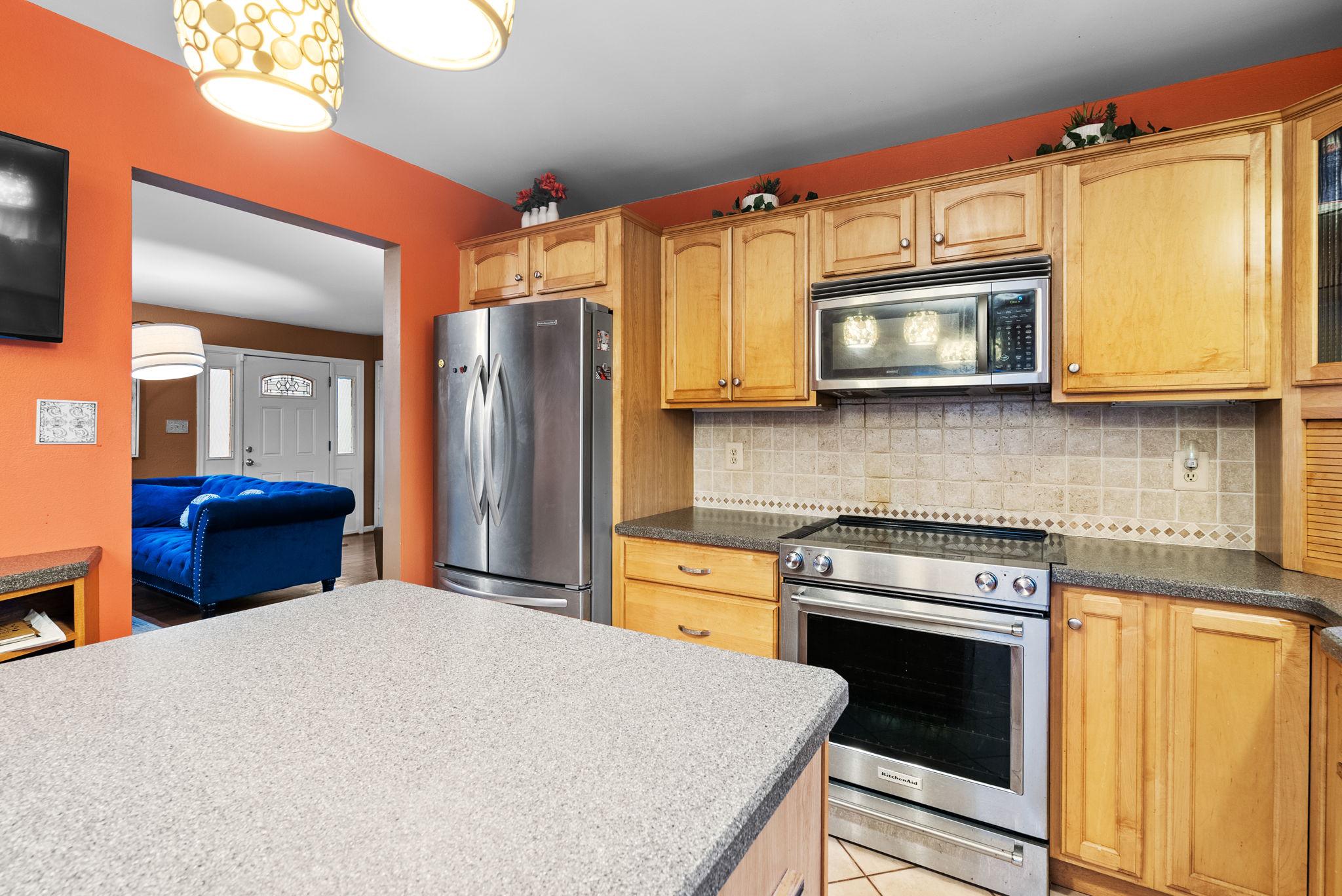 13100 Croom Road Upper Marlboro, MD 20772 - Photo 10 of 34 a kitchen with stainless steel appliances granite countertop a stove a microwave and a refrigerator