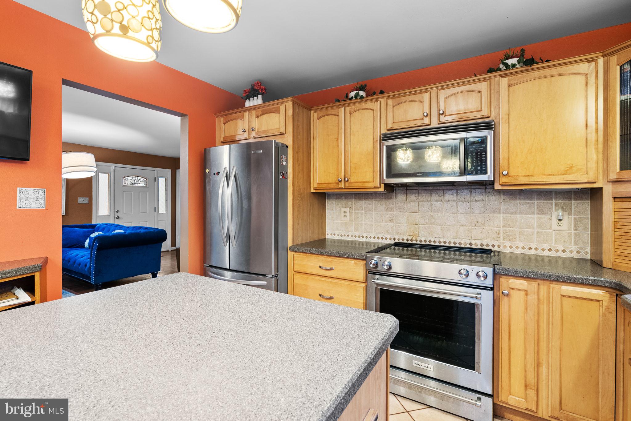 13100 Croom Road Upper Marlboro, MD 20772 - Photo 10 of 37 a kitchen with stainless steel appliances granite countertop a stove a microwave and a refrigerator