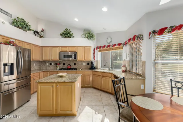 a kitchen with a sink appliances and cabinets