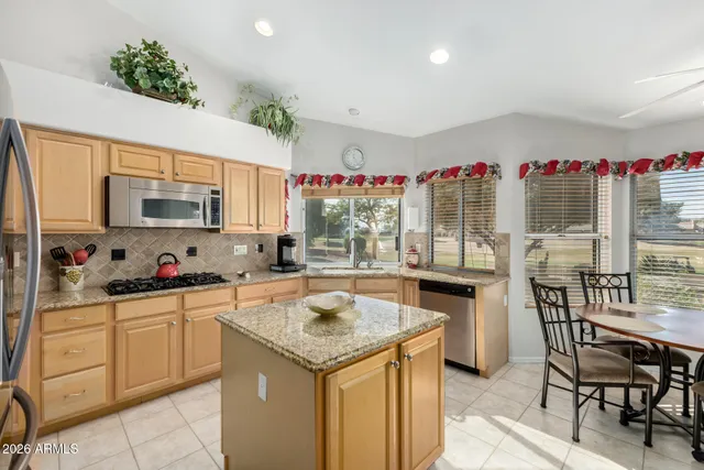 a kitchen with granite countertop a sink and cabinets
