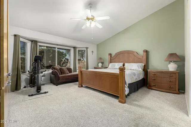 a bedroom with furniture and a large window