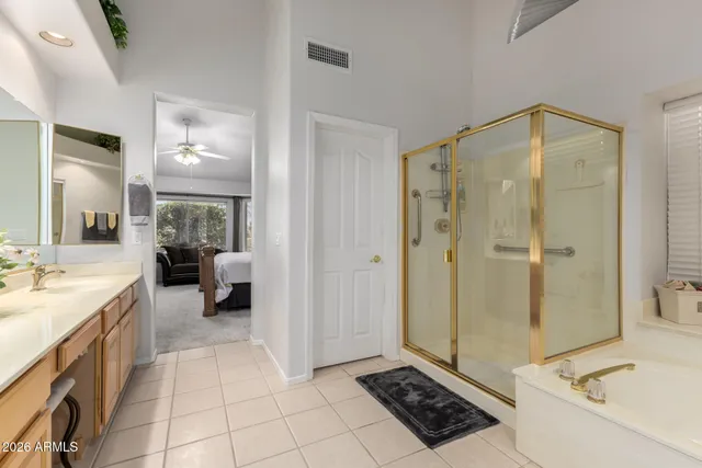 a bathroom with a tub a sink and a mirror